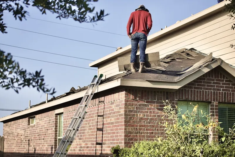 Professional roofer working on a residential roof in Davisville